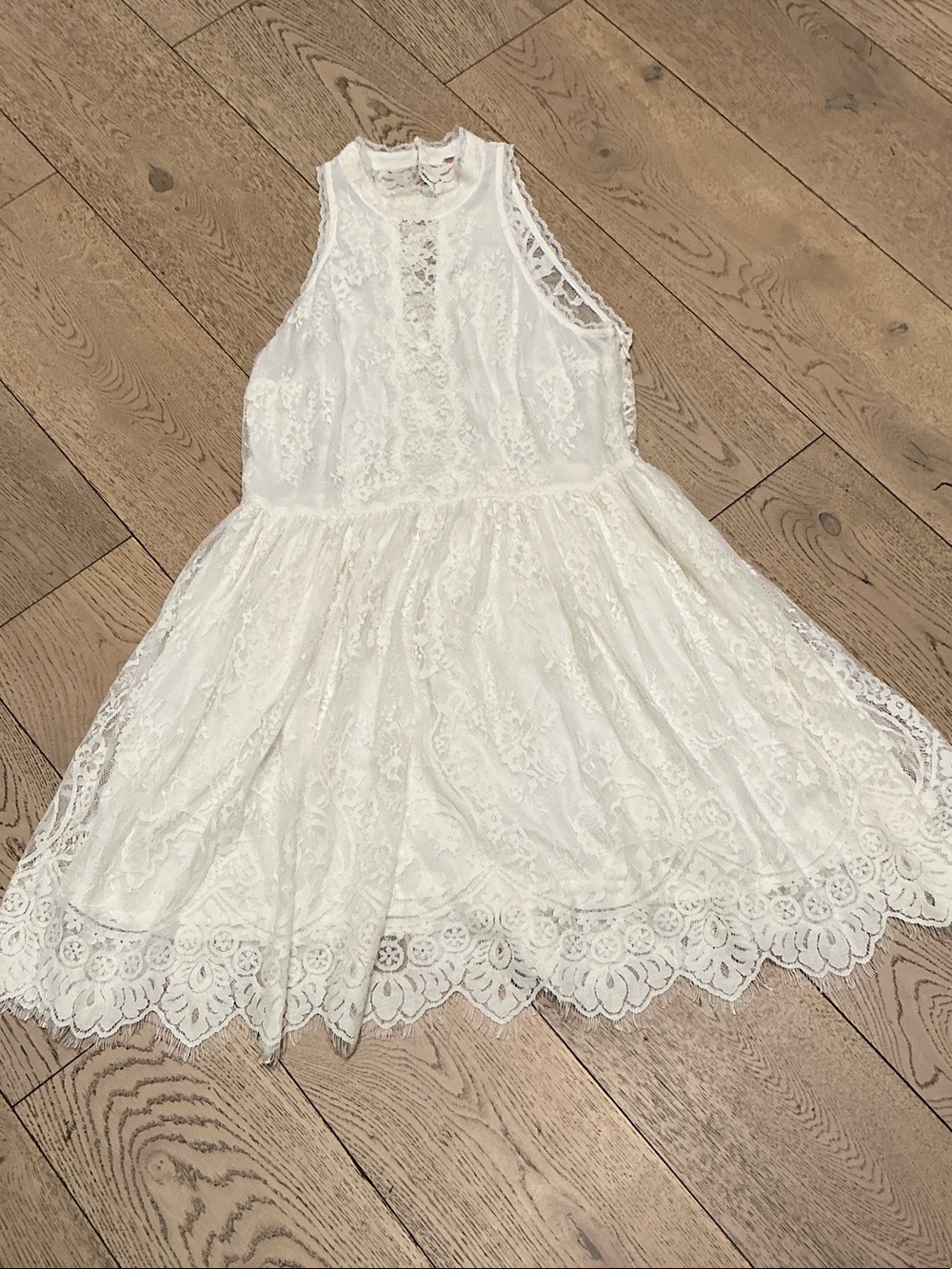 Woman’s Free People cream lace mini dress. Size 12. Lined. Scalloped back. Cute!